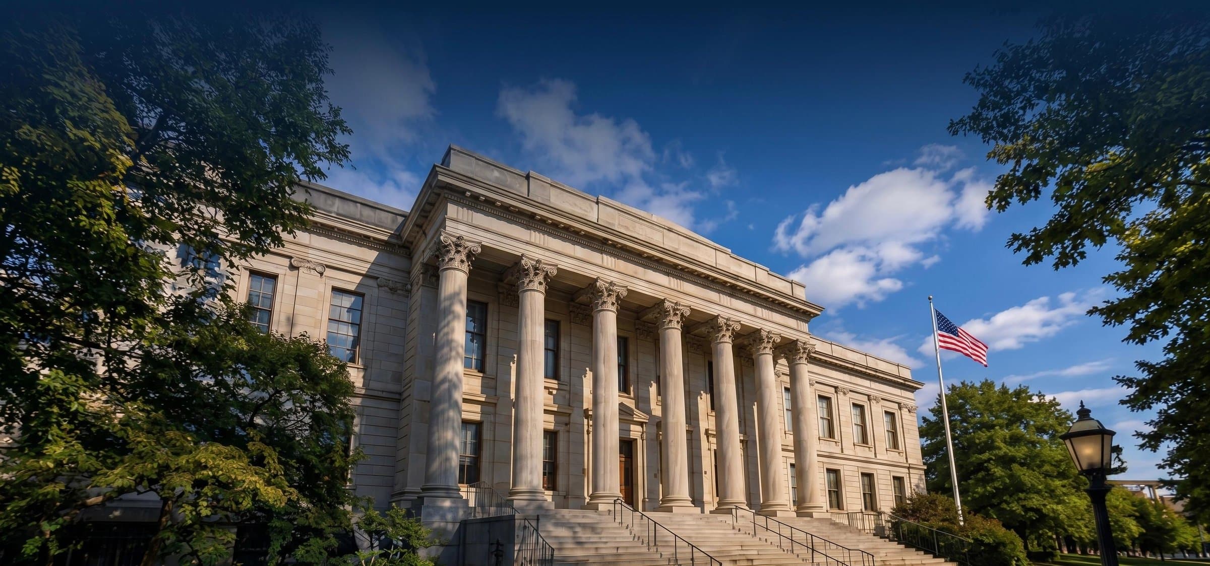 Exterior view of a Massachusetts courthouse with an American flag